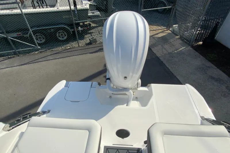 Slide: The Image of 2026 Cobalt R6 Outboard boat with sleek design, viewed from above in a marina setting. - 21