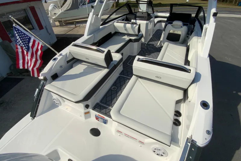 Slide: The Image of 2026 Cobalt R6 Outboard boat interior with white seating and American flag. - 23
