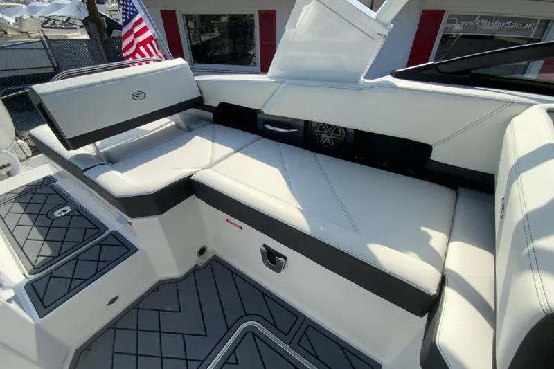 Slide: The Image of 2026 Cobalt R6 Outboard boat interior with white seating and American flag. - 28