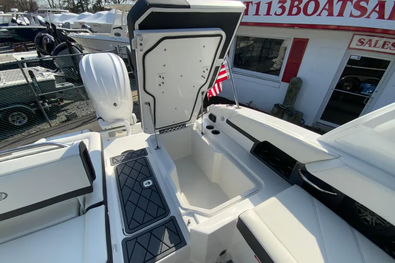 Slide: The Image of 2026 Cobalt R6 Outboard boat interior with open storage compartment and seating. - 29
