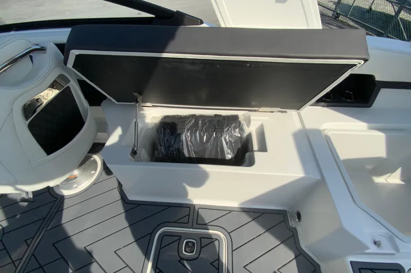 Slide: The Image of 2026 Cobalt R6 Outboard boat interior with open storage compartment and modern seating. - 31