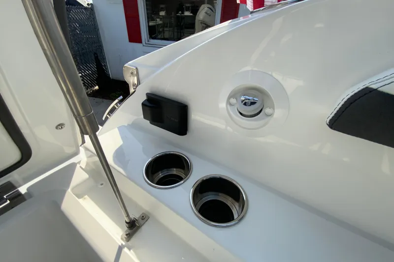 Slide: The Image of 2026 Cobalt R6 Outboard boat interior with cup holders and sleek design. - 34