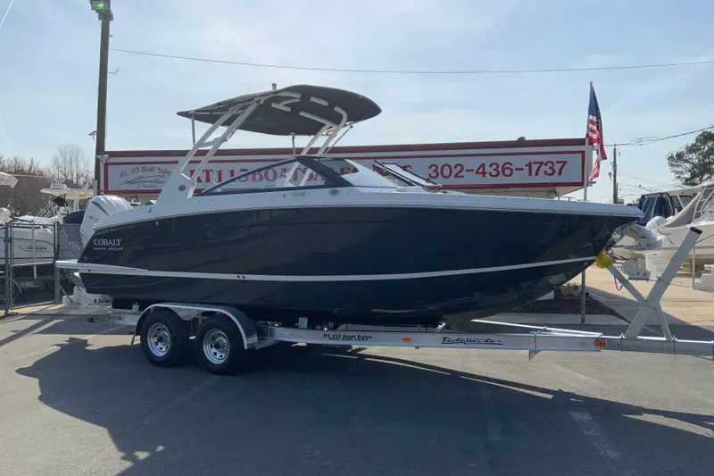 Slide: The Image of 2026 Cobalt R6 Outboard boat on trailer at dealership, side view. - 4