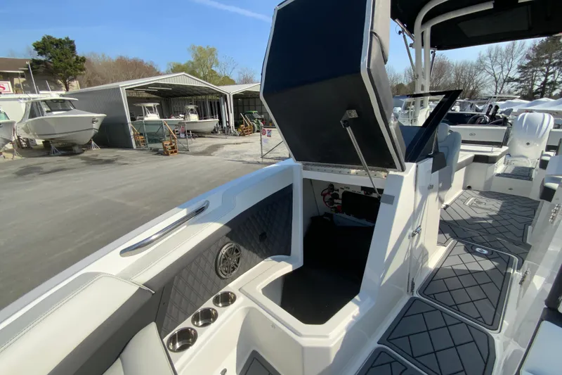 Slide: The Image of 2026 Cobalt R6 Outboard boat interior with open storage compartment and sleek design. - 56