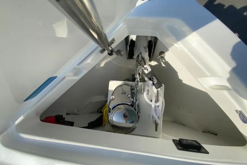 Slide: The Image of Anchor compartment of 2026 Cobalt R6 Outboard boat, featuring chain and winch system. - 61