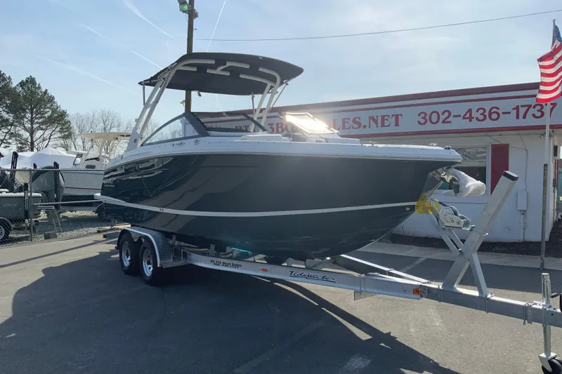 Slide: The Image of 2026 Cobalt R6 Outboard boat on trailer at dealership, sunny day. - 7