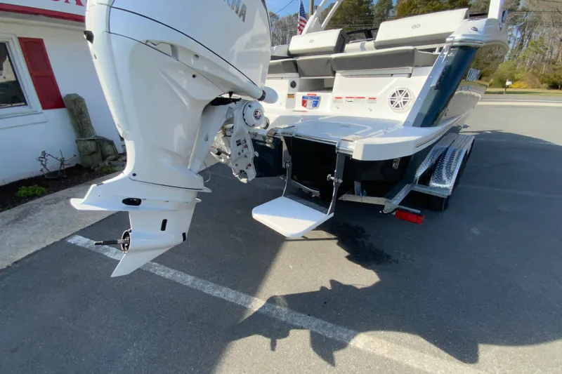 Slide: The Image of 2026 Cobalt R6 Outboard boat with powerful engine, parked on a trailer in a sunny setting. - 73