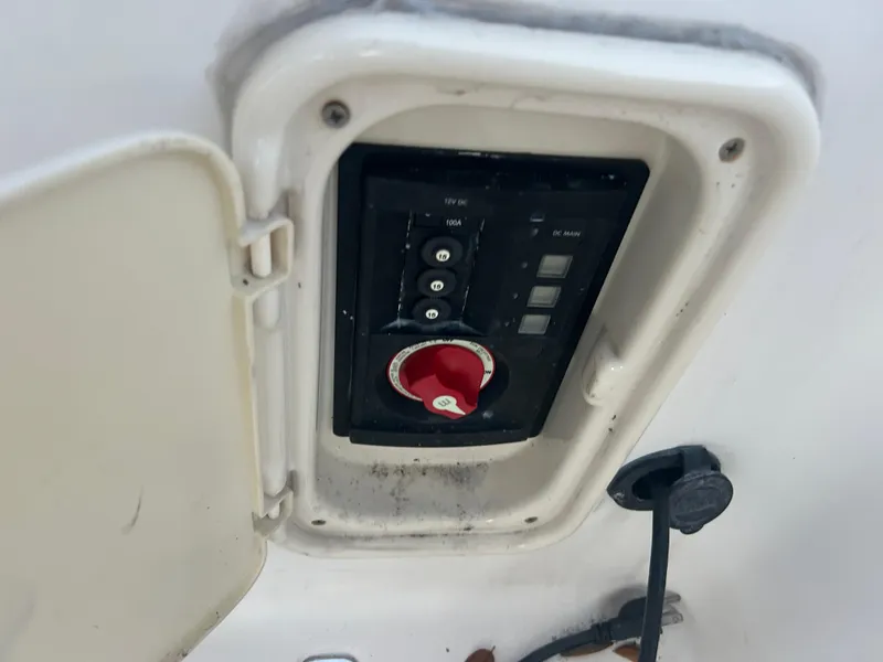 Slide: The Image of 2009 Cobia 216 Center Console boat control panel with red switch. - 17