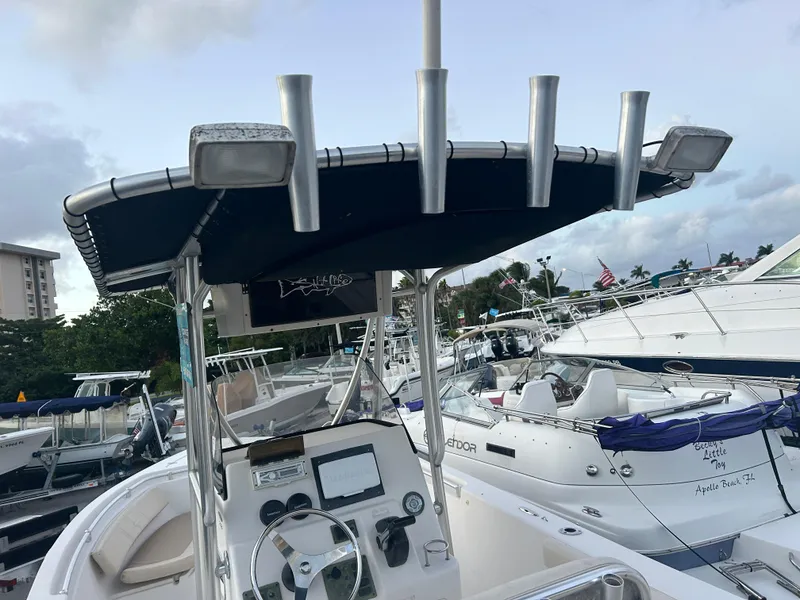 Slide: The Image of 2009 Cobia 216 Center Console boat with T-top and navigation equipment in marina. - 18