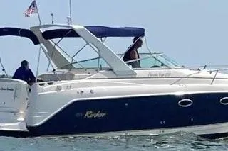 The Image of 2005 Rinker Fiesta Vee 270 boat on water, featuring sleek design and blue accents. - 0