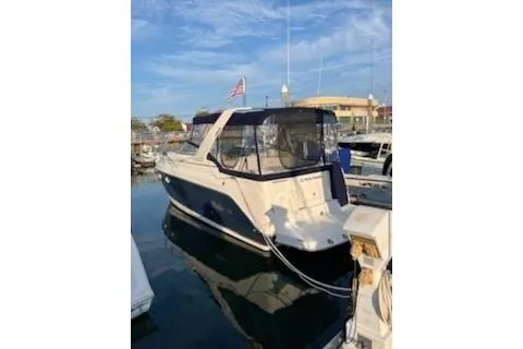 Slide: The Image of 2005 Rinker Fiesta Vee 270 boat docked at marina under clear sky. - 2