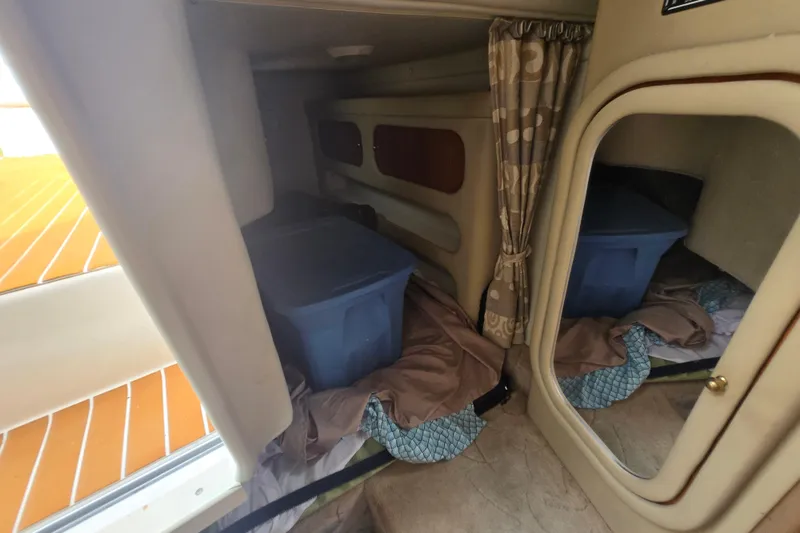 Slide: The Image of Interior cabin of 2005 Rinker Fiesta Vee 270 with storage bin and mirror. - 23