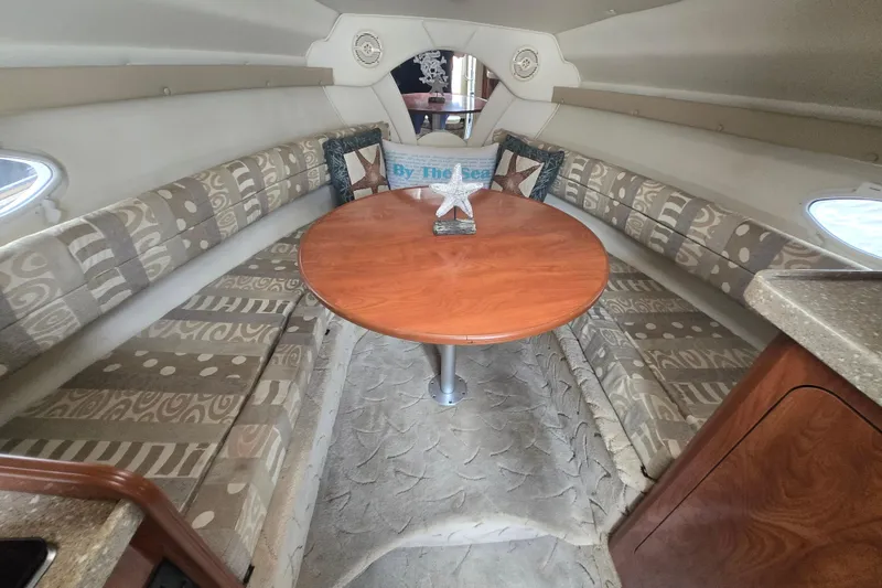 Slide: The Image of Interior of 2005 Rinker Fiesta Vee 270 boat with cozy seating and round table. - 24