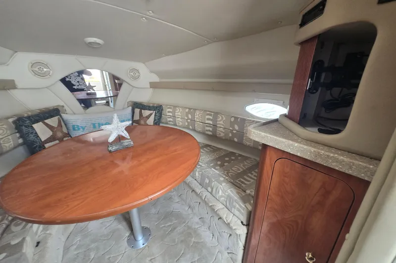 Slide: The Image of Interior of 2005 Rinker Fiesta Vee 270 boat with cozy seating and wooden table. - 25