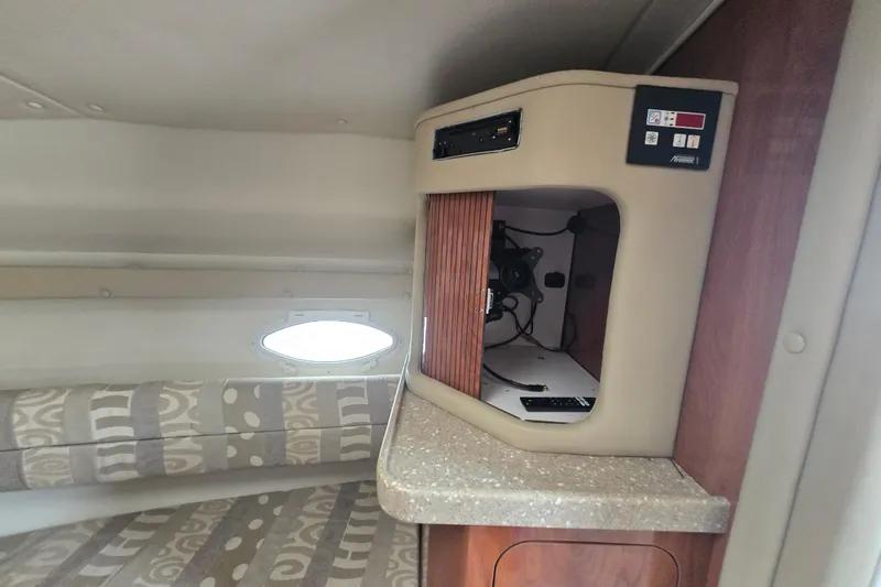 Slide: The Image of 2005 Rinker Fiesta Vee 270 cabin interior with seating and storage compartment. - 26