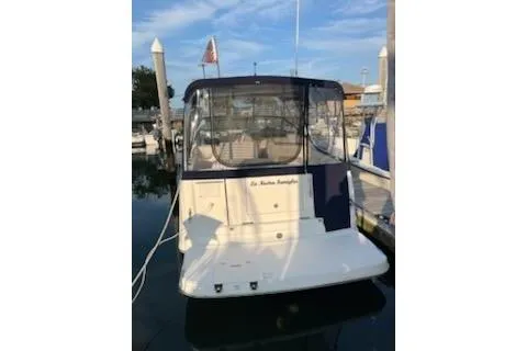 Slide: The Image of 2005 Rinker Fiesta Vee 270 boat docked at marina, rear view with canopy. - 4