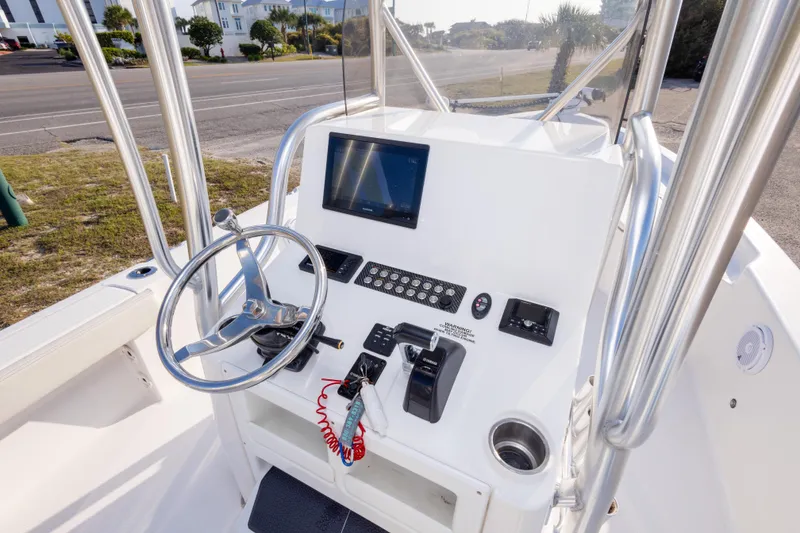 Slide: The Image of 2021 Blue Wave 2600 PureBay boat console with steering wheel and navigation display. - 17