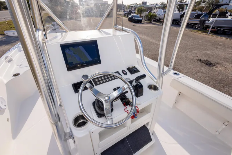 Slide: The Image of 2021 Blue Wave 2600 PureBay boat console with steering wheel and navigation display. - 18