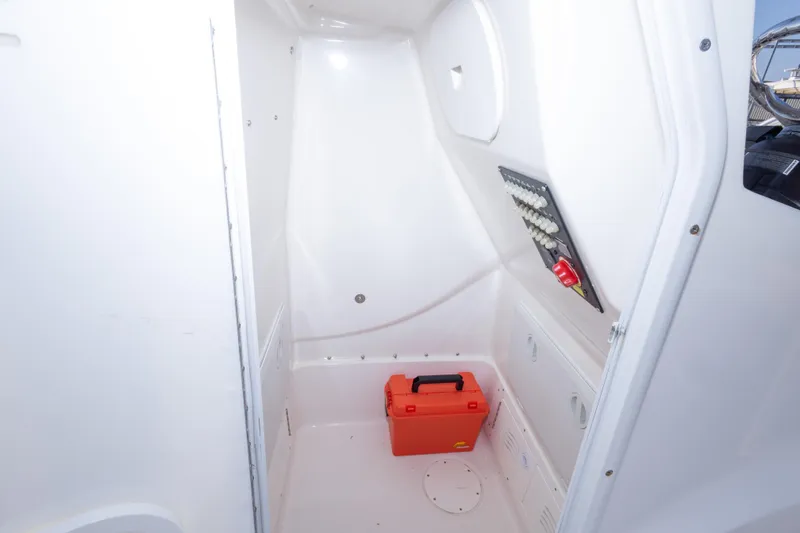 Slide: The Image of Interior of 2021 Blue Wave 2600 PureBay boat with storage compartment and control panel. - 21