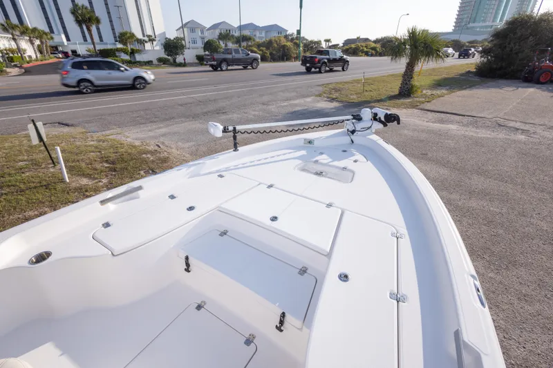 Slide: The Image of 2021 Blue Wave 2600 PureBay boat parked near a road with passing vehicles. - 23