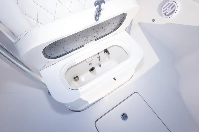 Slide: The Image of Livewell compartment on a 2021 Blue Wave 2600 PureBay boat, featuring a white interior. - 29