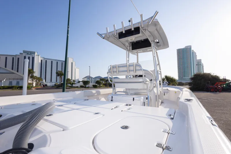 Slide: The Image of 2021 Blue Wave 2600 PureBay boat docked near modern buildings under clear sky. - 37