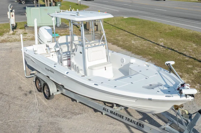 Slide: The Image of 2021 Blue Wave 2600 PureBay boat on trailer, parked near a road. - 38