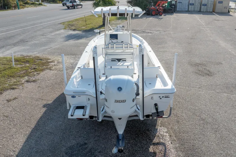 Slide: The Image of 2021 Blue Wave 2600 PureBay boat with Yamaha 300 engine, parked on pavement. - 41