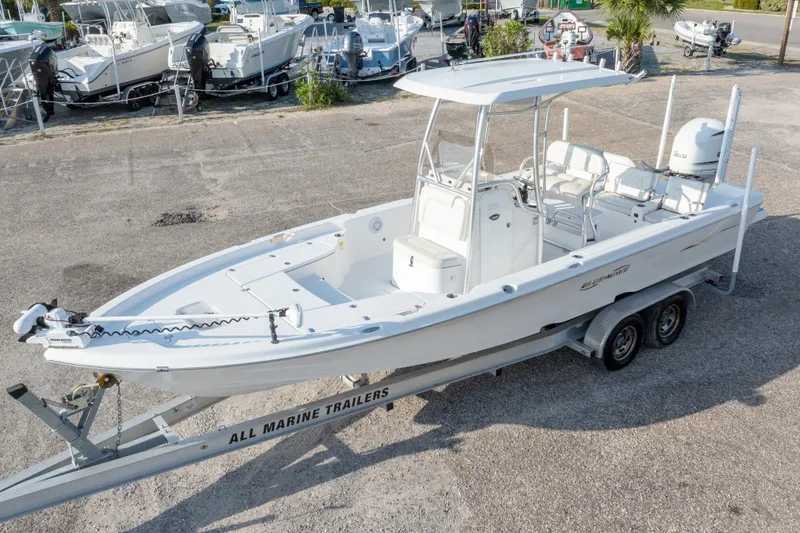 Slide: The Image of 2021 Blue Wave 2600 PureBay boat on trailer, parked in a marina lot. - 44
