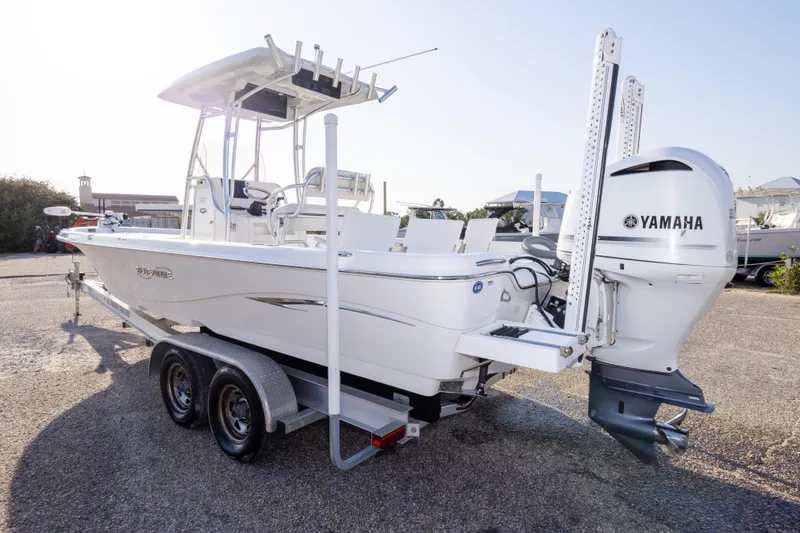 Slide: The Image of 2021 Blue Wave 2600 PureBay boat with Yamaha engine on trailer in sunny setting. - 7