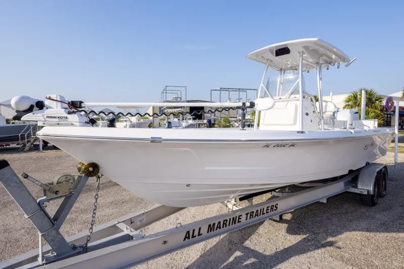 Slide: The Image of 2021 Blue Wave 2600 PureBay boat on trailer, displayed outdoors. - 9