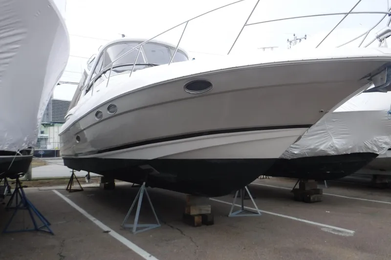 The Image of 2006 Regal Commodore 3560 IO boat on stands in a parking lot. - 0
