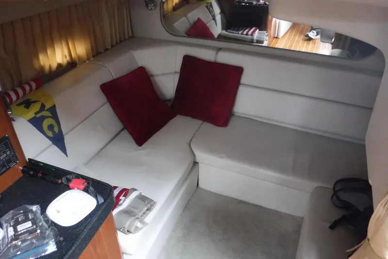 Slide: The Image of Interior of 2006 Regal Commodore 3560 IO with white seating and red cushions. - 11