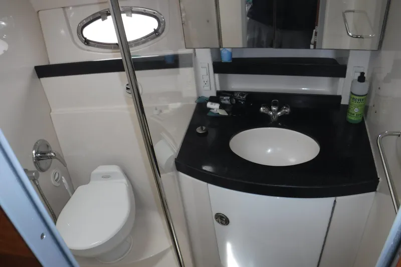 Slide: The Image of Bathroom interior of 2006 Regal Commodore 3560 IO yacht, featuring sink and toilet. - 14