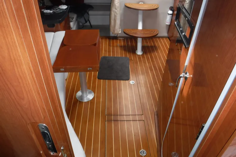 Slide: The Image of Interior of 2006 Regal Commodore 3560 IO yacht with wooden flooring and seating area. - 15