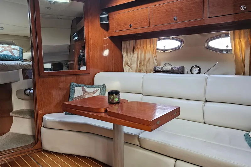 Slide: The Image of Interior of 2006 Regal Commodore 3560 yacht with elegant seating and wooden accents. - 16