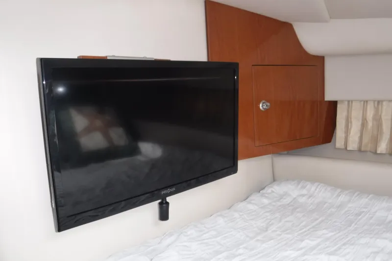 Slide: The Image of Flat-screen TV in 2006 Regal Commodore 3560 IO cabin, mounted on wall above bed. - 17