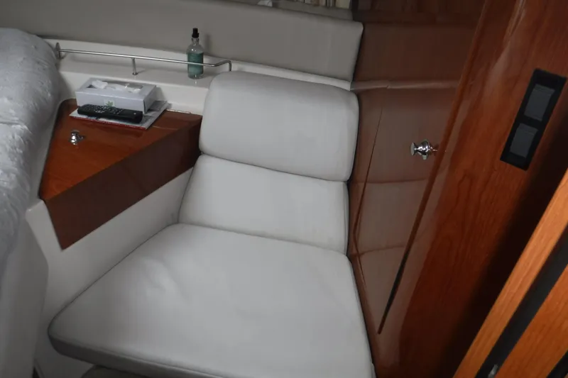 Slide: The Image of Interior of 2006 Regal Commodore 3560 IO with white seating and wooden accents. - 18