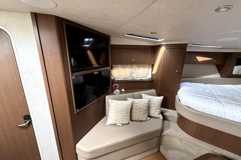 Slide: The Image of Manufacturer Provided Image: Interior cabin of 2013 Sea Ray 350 Sundancer with beige seating and modern design. - 13