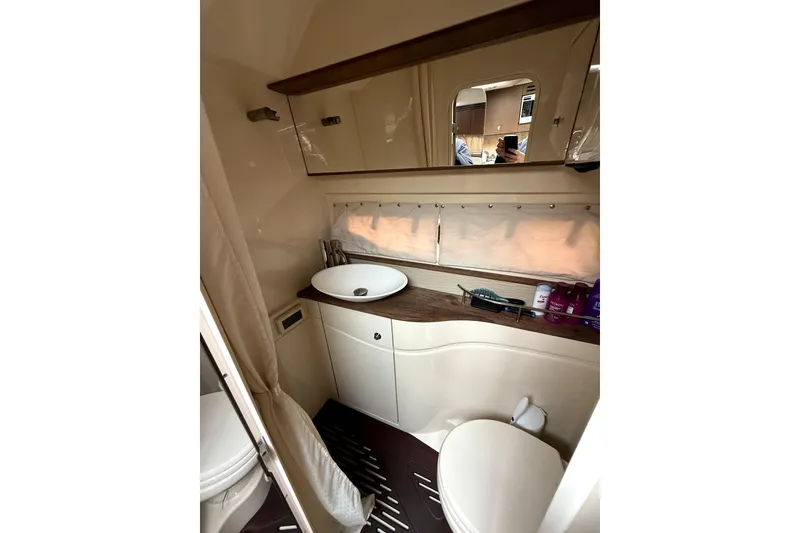 Slide: The Image of Control panel of a 2013 Sea Ray Sundancer 350 boat with various switches and keys. - 15