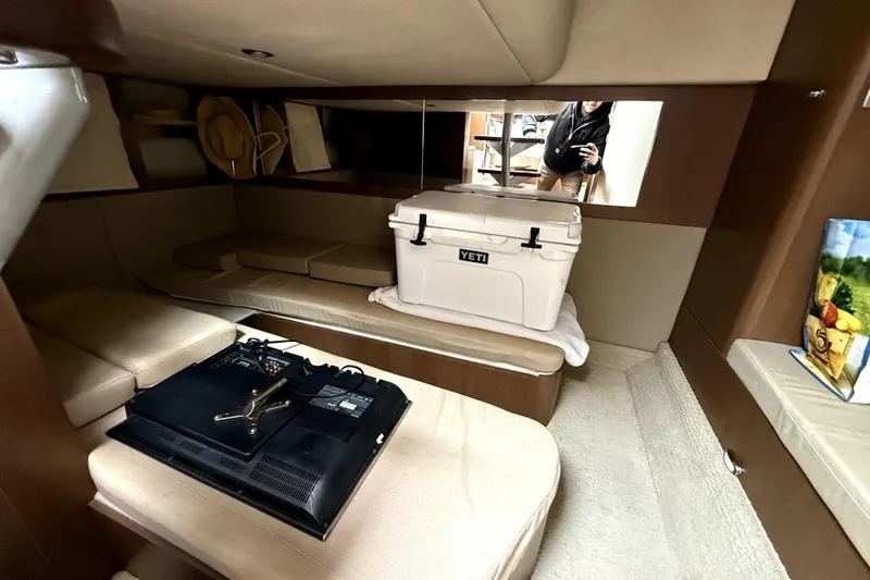 Slide: The Image of Luxurious interior of 2013 Sea Ray Sundancer 350 with beige seating and wooden table. - 16