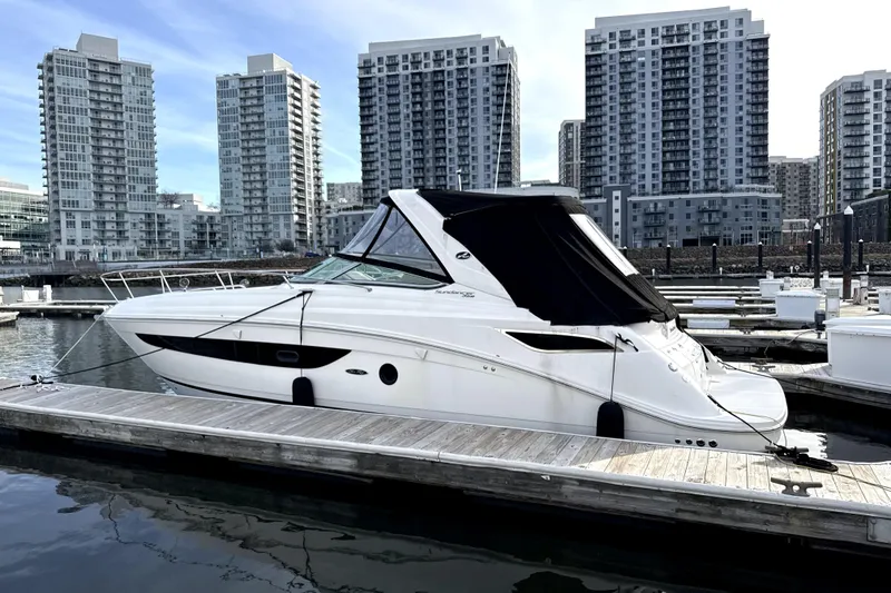 Slide: The Image of 2013 Sea Ray Sundancer 350 docked at marina, rear view with black cover. - 2