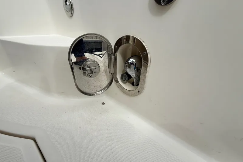 Slide: The Image of 2013 Sea Ray Sundancer 350 boat fuel cap and compartment detail. - 22
