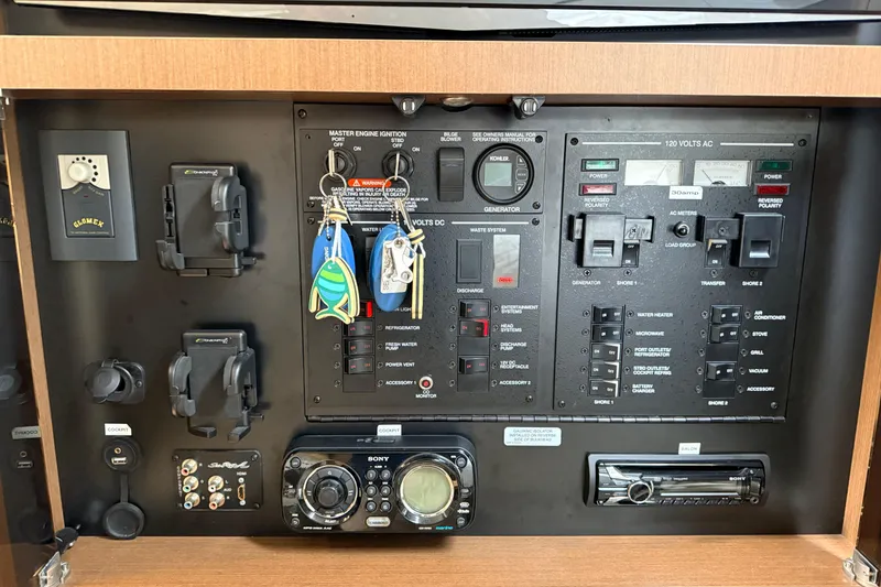 Slide: The Image of Control panel of a 2013 Sea Ray Sundancer 350 boat with various switches and keys. - 23