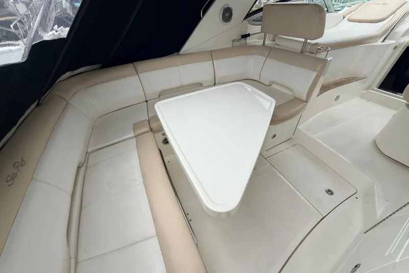 Slide: The Image of Interior seating area of 2013 Sea Ray Sundancer 350 with white and beige upholstery. - 24