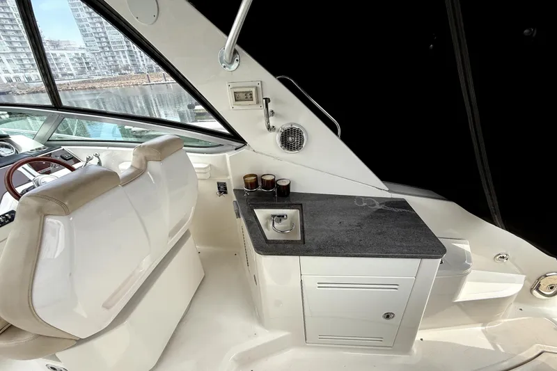 Slide: The Image of Manufacturer Provided Image: 2013 Sea Ray 350 Sundancer helm with steering wheel and control panel. - 4