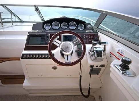 Slide: The Image of Cockpit of 2013 Sea Ray Sundancer 350 yacht with steering wheel and navigation controls. - 5