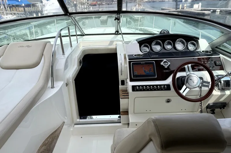 Slide: The Image of 2013 Sea Ray Sundancer 350 helm with navigation system and luxurious seating. - 6