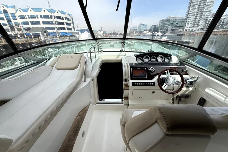 Slide: The Image of Compact kitchen area in a 2013 Sea Ray Sundancer 350 yacht, featuring modern appliances and wood finishes. - 7