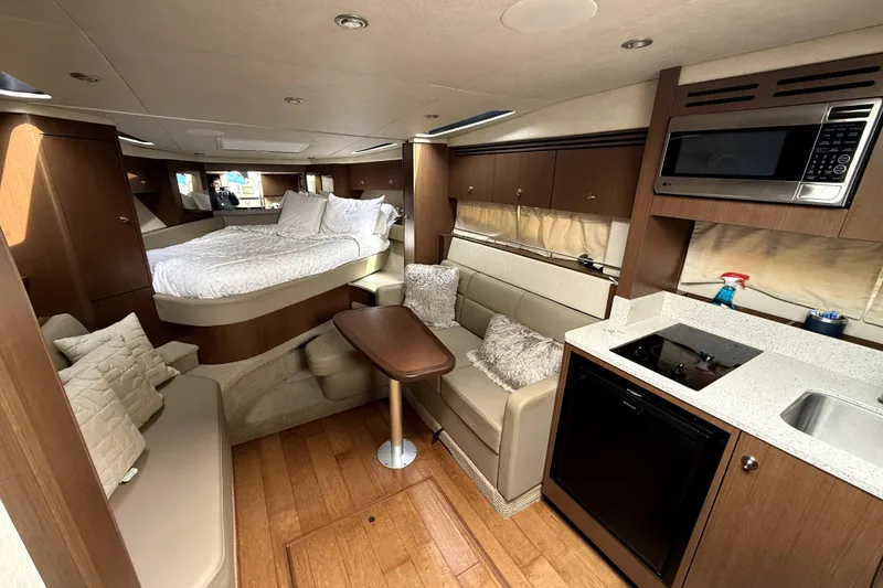 Slide: The Image of Interior of 2013 Sea Ray Sundancer 350 yacht with TV and wooden staircase. - 8